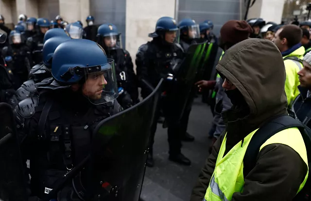 police officials face protesters on december 8 2018 in paris on the champs elysees avenue during a quot yellow vests quot gilets jaunes protests against rising costs of living they blame on high taxes photo afp police officials face protesters on december 8 2018 in paris on the champs elysees avenue during a quot yellow vests quot gilets jaunes protests against rising costs of living they blame on high taxes photo afp