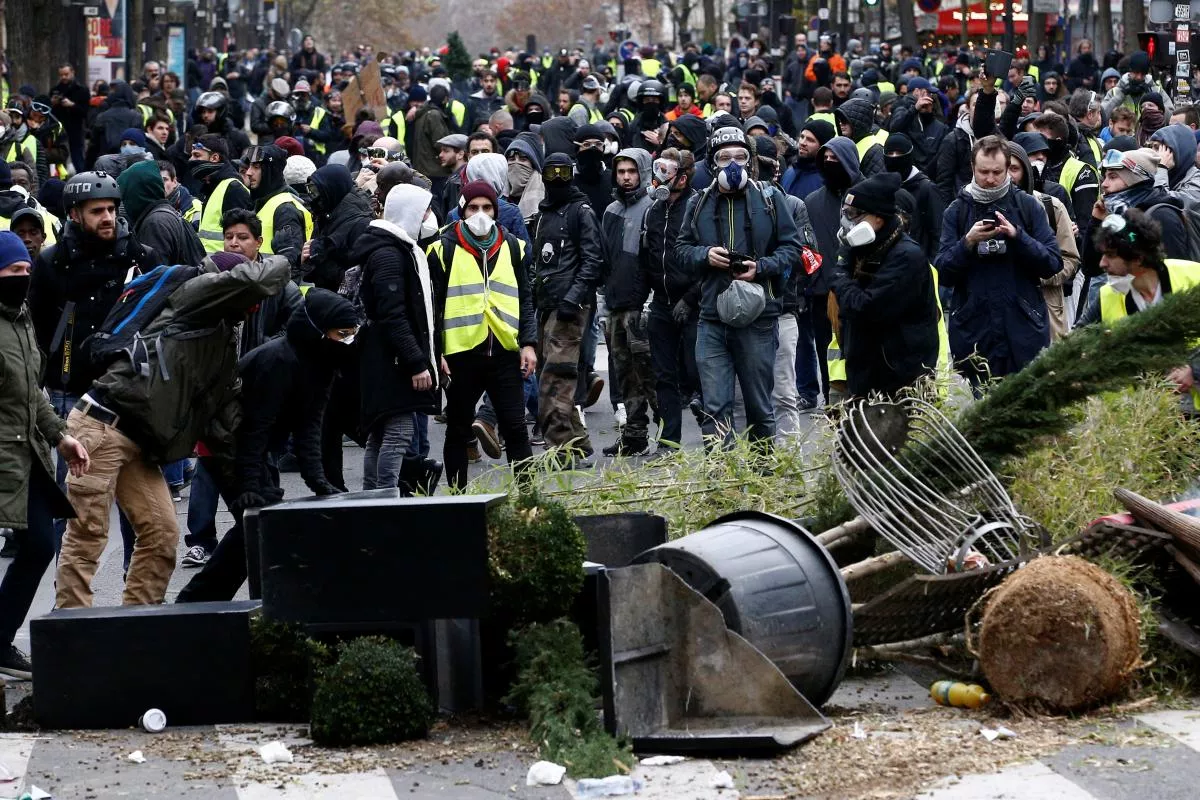 protesters wearing yellow vests install a barricade during clashes with police at a demonstration during a national day of protest by the quot yellow vests quot movement in paris france photo reuters