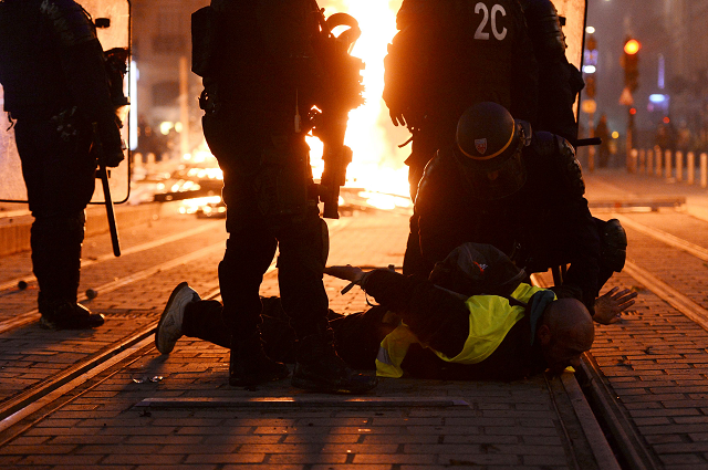 riot police officers detain a protestor photo afp