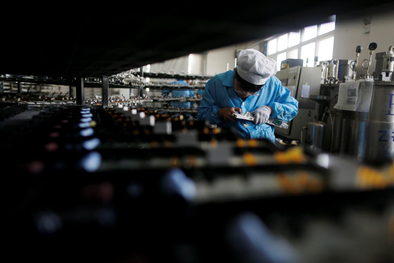 a labourer works inside an electronics factory photo reuters