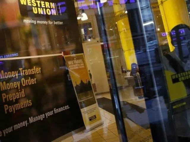 a person walks out of a western union branch in new york photo reuters a person walks out of a western union branch in new york photo reuters
