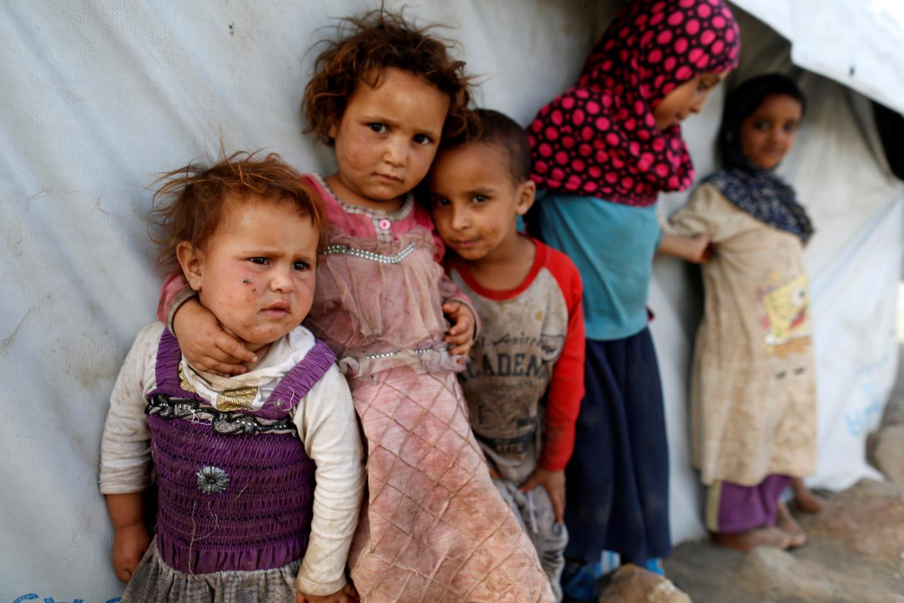 children stand next to a tent at a camp for people displaced by the war near sanaa yemen april 24 2017 photo reuters