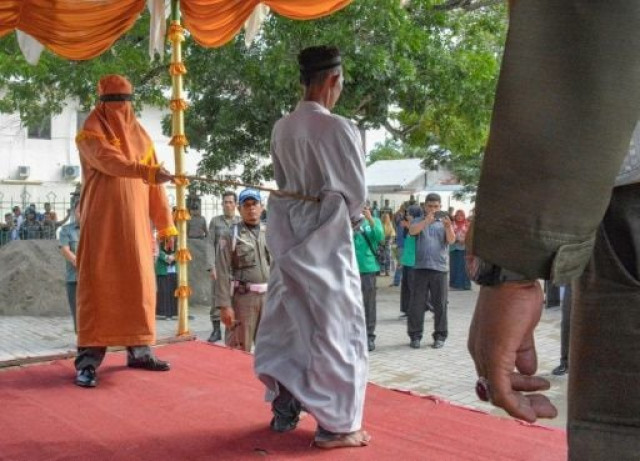 dozens in the crowd in indonesia 039 s conservative muslim province of aceh jeered and called for the men to be whipped harder photo afp