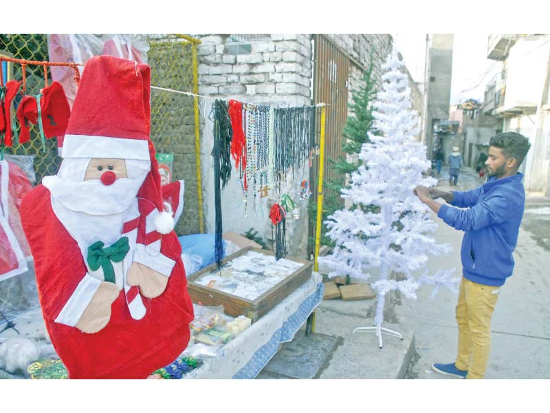 a vendor displays decorative items for christmas at his setup in islamabad photo online