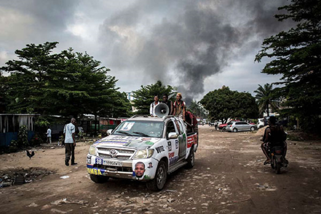 electoral banners are seen as smoke rises from a fire at the independent national electoral commission 039 s ceni warehouse on december 13 2018 in kinshasa ten days ahead of presidential elections that have been foreshadowed by violence photo afp electoral banners are seen as smoke rises from a fire at the independent national electoral commission 039 s ceni warehouse on december 13 2018 in kinshasa ten days ahead of presidential elections that have been foreshadowed by violence photo afp