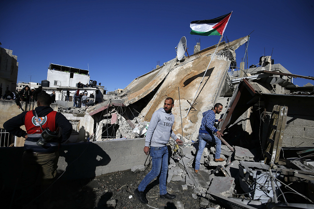 people gather at the scene where the house belonging to a palestinian accused of killing an israeli soldier a few months ago was blown up by israeli troops in ramallah in the israeli occupied west bank on december 15 2018 photo afp people gather at the scene where the house belonging to a palestinian accused of killing an israeli soldier a few months ago was blown up by israeli troops in ramallah in the israeli occupied west bank on december 15 2018 photo afp