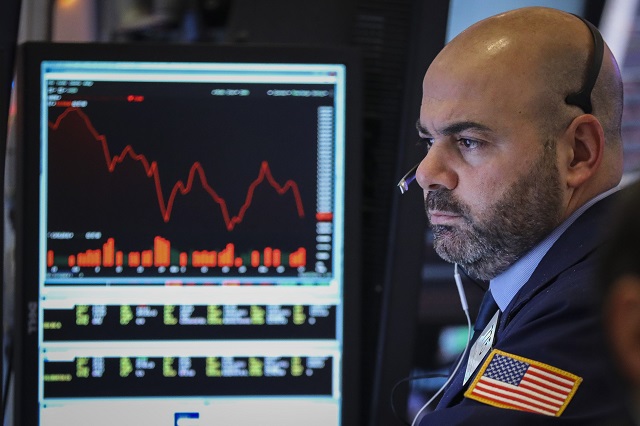a trader works at his desk at the closing bell on the floor of the new york stock exchange nyse