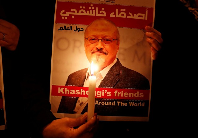 a demonstrator holds a poster with a picture of saudi journalist jamal khashoggi outside the saudi arabia consulate in istanbul turkey photo reuters