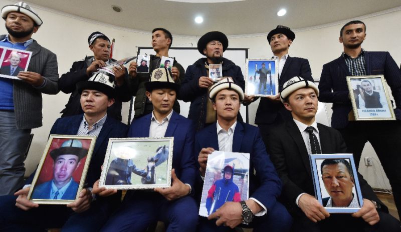 kyrgyz family members hold portraits of their relatives who they fear are being held in notorious quot re education camps quot in china 039 s xinjiang region photo afp