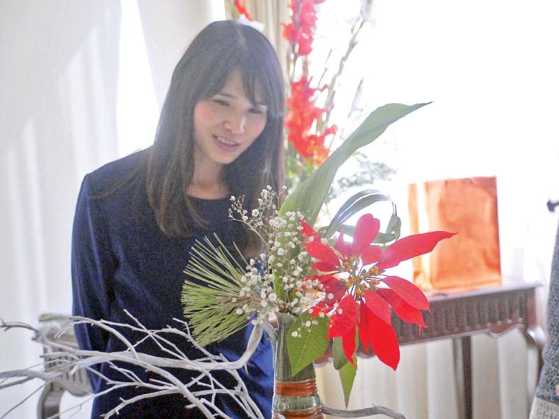 wife of the japanese ambassador madam rieko kurai explains floral arrangement during an ikebana exhibition held at her home on tuesday photo dna