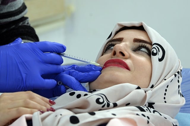 an iraqi woman gets a lip injection at a beauty clinic in the northern city of mosul photo afp