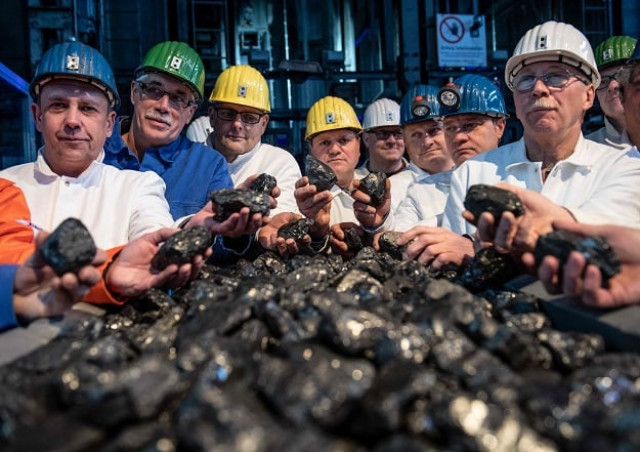 miners pose with coal out of the last mined dram at the shaft in the pit in ibbenbueren western germany photo afp miners pose with coal out of the last mined dram at the shaft in the pit in ibbenbueren western germany photo afp