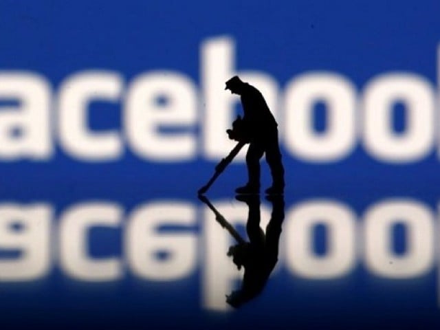 a figurine is seen in front of the facebook logo in this illustration taken march 20 2018 photo reuters