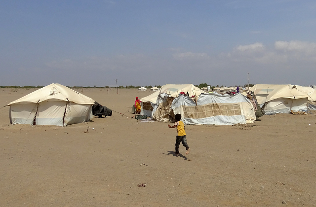 a yemeni child runs toward a tent at a camp for displaced people in the khokha district of the western province of hodeidah on december 11 2018 photo afp