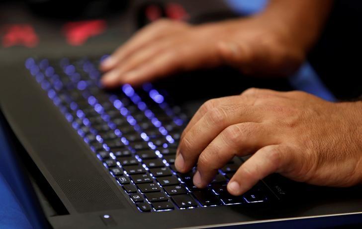 a man types into a keyboard photo reuters