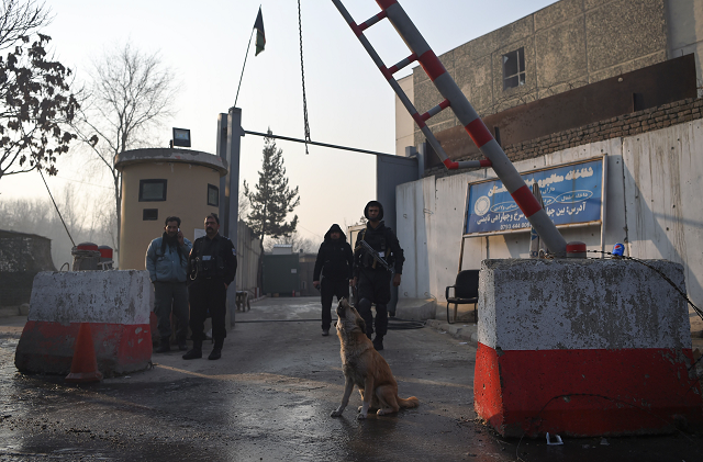 afghan policemen stand guard at the entrance gate of the ministry of public works a day after a deadly militant attack in kabul photo afp