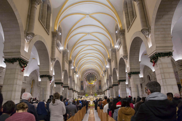 archbishop pierbattista pizzaballa the top roman catholic cleric in the holy land heads a christmas midnight mass at saint catherine 039 s church photo afp