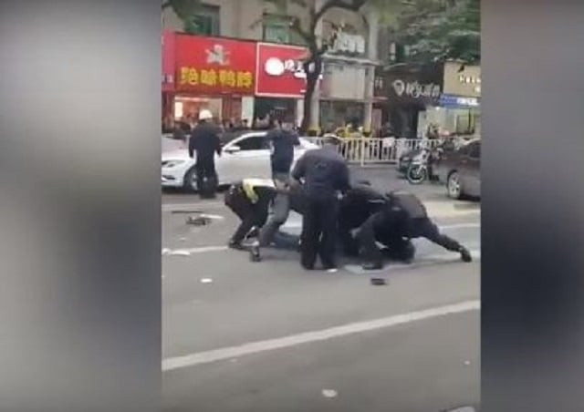 screengrab of video footage circulating online said to be showing police subduing one of the attackers in china 039 s fujian province screengrab of video footage circulating online said to be showing police subduing one of the attackers in china 039 s fujian province