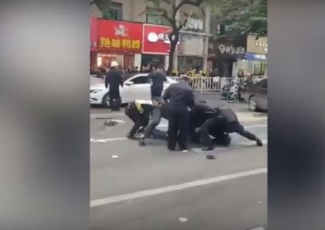 screengrab of video footage circulating online said to be showing police subduing one of the attackers in china 039 s fujian province