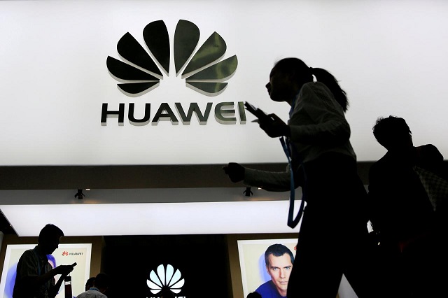 file photo people walk past a sign board of huawei at ces consumer electronics show asia 2016 in shanghai china may 12 2016 photo reuters