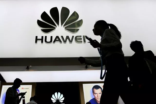 file photo people walk past a sign board of huawei at ces consumer electronics show asia 2016 in shanghai china may 12 2016 photo reuters file photo people walk past a sign board of huawei at ces consumer electronics show asia 2016 in shanghai china may 12 2016 photo reuters