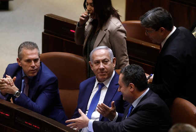 israeli prime minister benjamin netanyahu sits among members of his government during a parliament session in jerusalem on december 26 2018