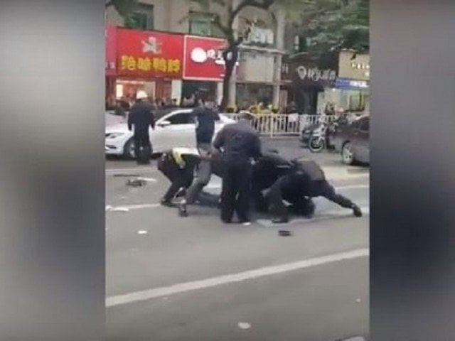 screengrab of video footage circulating online said to be showing police subduing one of the attackers in china 039 s fujian province screengrab of video footage circulating online said to be showing police subduing one of the attackers in china 039 s fujian province