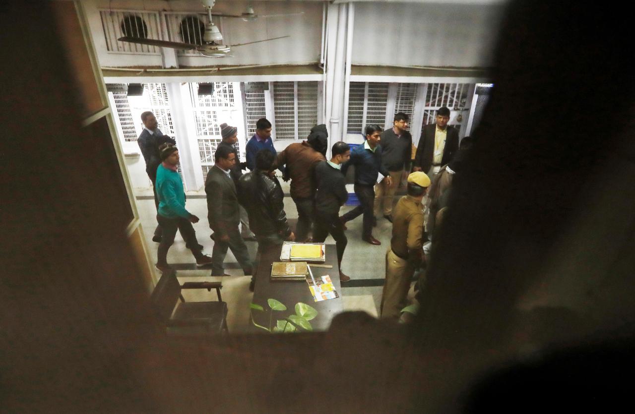 policemen escort two men who got arrested along with eight more suspected of planning imminent suicide attacks in new delhi region as they leave a court in new delhi india photo reuters