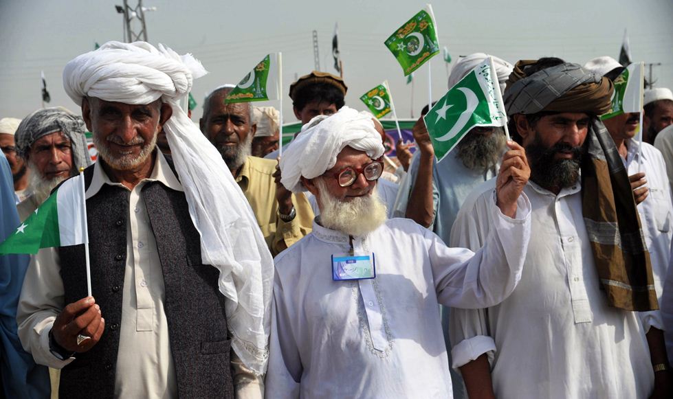 in this file photo internally displaced persons fleeing zarb e azb in north waziristan hold national flags during a ceremony to mark the independence day in bannu on august 14 2014 photo afp