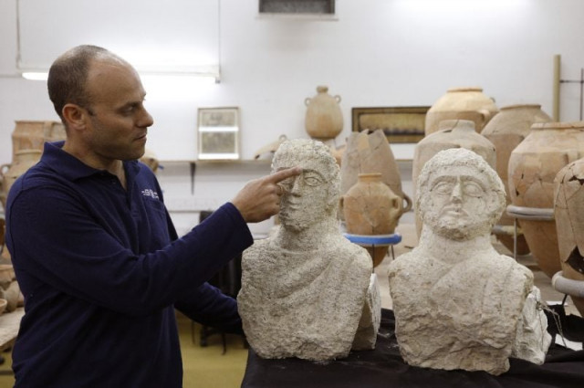 israeli archaeologist eitan klein of the israel antiquities authority shows off two late roman busts unearthed near the ancient city of beit shean following a chance find by a woman walker photo afp israeli archaeologist eitan klein of the israel antiquities authority shows off two late roman busts unearthed near the ancient city of beit shean following a chance find by a woman walker photo afp