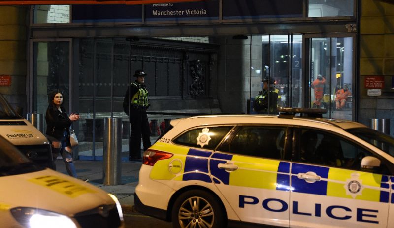 police officers stand near a cordon at manchester victoria station following a stabbing photo afp