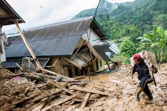 a resident carries his livestock following a landslide at cisolok district in sukabumi west java province indonesia january 1 2019 photo reuters a resident carries his livestock following a landslide at cisolok district in sukabumi west java province indonesia january 1 2019 photo reuters