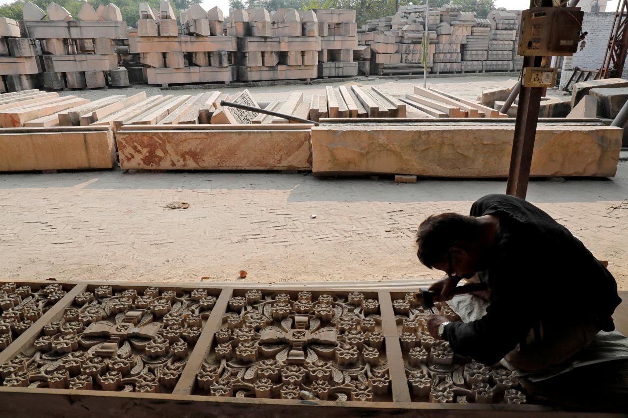 a worker engraves a stone that hindu groups say will be used to build a ram temple at a disputed religious site in ayodhya in the northern state of uttar pradesh india photo reuters