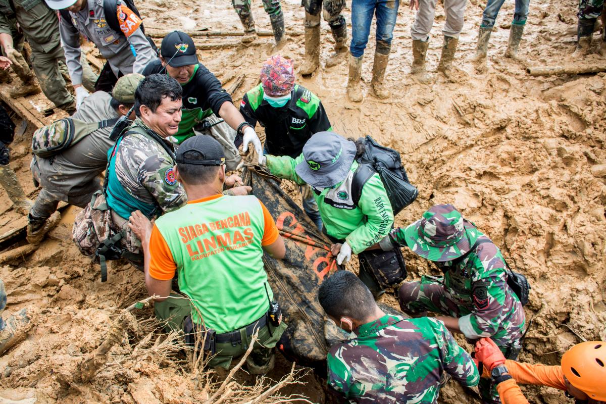 rescue workers carry a body bag containing remains of victims following a landslide at cisolok district in sukabumi west java province indonesia photo reuters