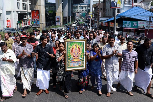 protesters carry a picture of the hindu deity ayyappa at a demonstration following the entry of two women to the sabarimala temple in kochi in southern kerala state on jan 2 2019 photo afp