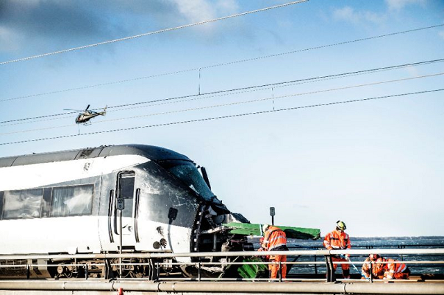 investigators said the passenger train appeared to have struck an empty truck trailer that had blown off a cargo train photo afp investigators said the passenger train appeared to have struck an empty truck trailer that had blown off a cargo train photo afp