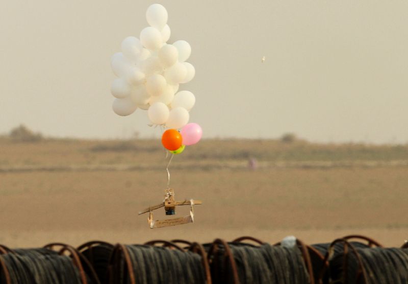 israeli side of the border with the gaza strip shows balloons carrying an alleged incendiary device launched by palestinian protesters photo afp