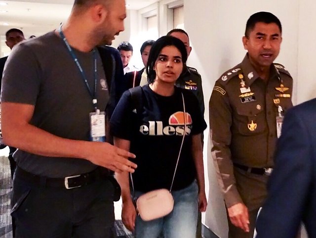 this handout picture taken and released by thai immigration bureau on january 7 2019 shows 18 year old saudi woman rahaf mohammed al qanun 2nd l is being escorted by the thai immigration officer and united nations high commissioner for refugees unhcr officials at the suvarnabhumi international airport in bangkok photo afp