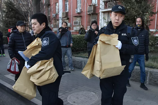 police investigators carry bags of evidence out of an elementary school where an attack took place in beijing photo afp police investigators carry bags of evidence out of an elementary school where an attack took place in beijing photo afp