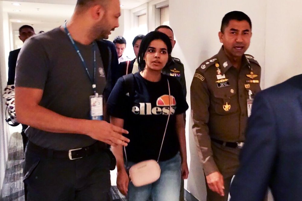 18 year old saudi woman rahaf mohammed al qanun c being escorted by a thai immigration officer r and united nations high commissioner for refugees unhcr officials at suvarnabhumi international airport in bangkok photo afp