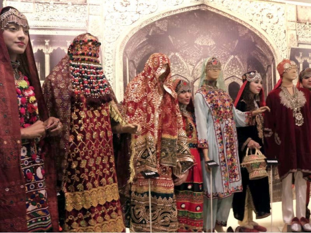 models pose at a display of wedding dresses from various regions of pakistan at lok virsa photo express