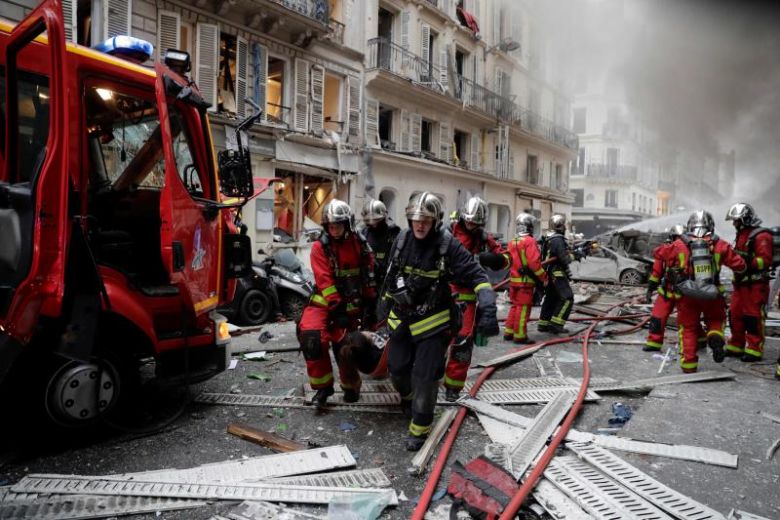 firefighters evacuate an injured person on a stretcher after an explosion at a bakery in central paris photo afp