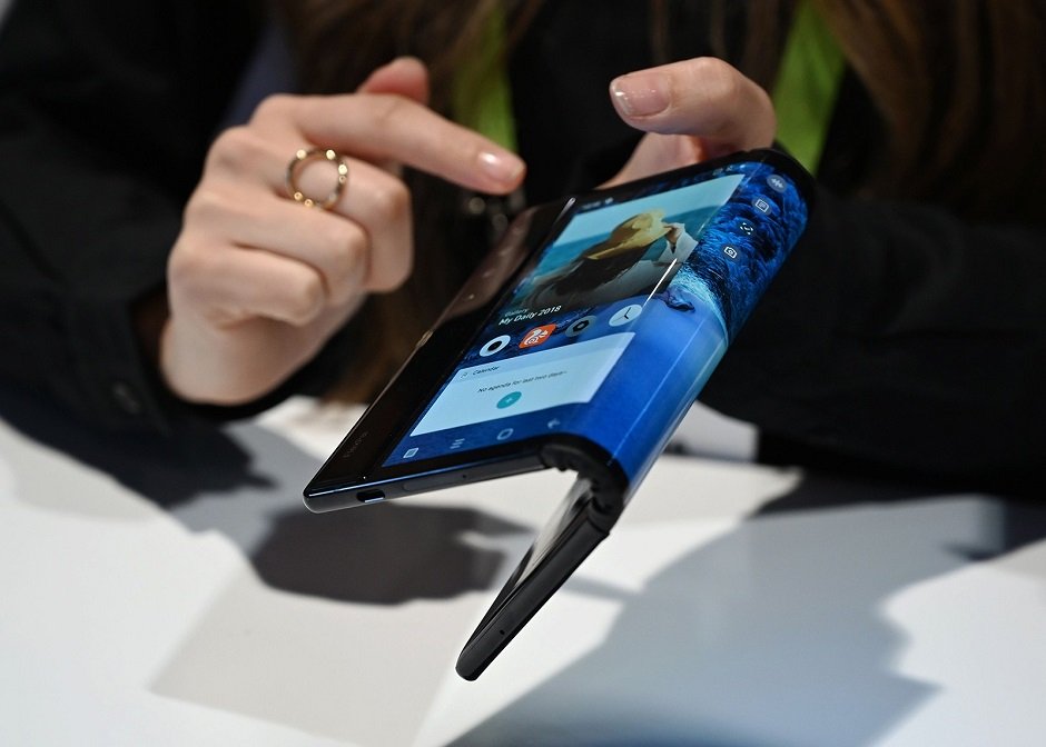 the folding and capabilities of the royole flexipai tablet and phone are demonstrated at the royole booth at ces international in las vegas photo afp