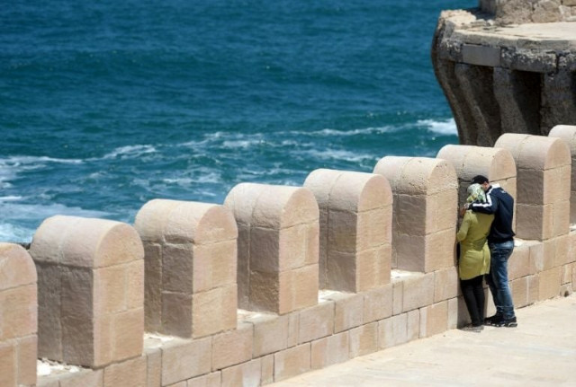 an egyptian couple embracing during a stroll on pharos island in the port of alexandria photo afp an egyptian couple embracing during a stroll on pharos island in the port of alexandria photo afp