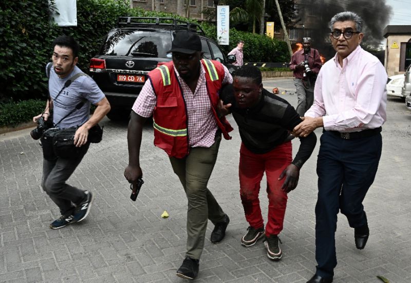 an injured man is evacuated from the dusit2 hotel and office complex photo afp