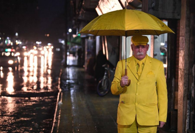abu zakkour known as the yellow man a symbol of peculiarity in the city walks down the street in aleppo syria photo xinhua abu zakkour known as the yellow man a symbol of peculiarity in the city walks down the street in aleppo syria photo xinhua