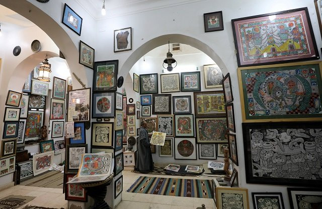 artist hassan el shark holds his piece of art at his gallery in minya governorate upper egypt photo reuters artist hassan el shark holds his piece of art at his gallery in minya governorate upper egypt photo reuters