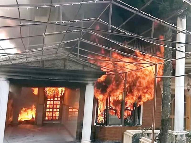 flames leap from a house after a fire broke out on tuesday while people look at the charred rooms photos agencies flames leap from a house after a fire broke out on tuesday while people look at the charred rooms photos agencies