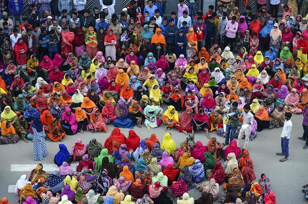 in this file photo taken on january 9 2019 bangladeshi garment workers block a road during a demonstration to demand higher wages in dhaka photo afp