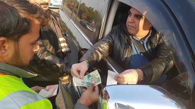 sindh governor imran ismail is seen paying fine for over speeding photo express